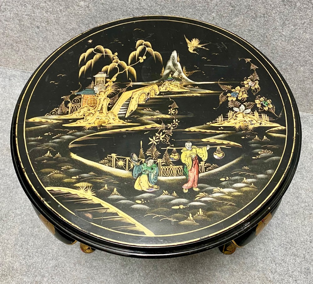 A round black lacquered coffee table with hand-painted gilded Chinoiserie landscape scenes and cabriole legs. View V