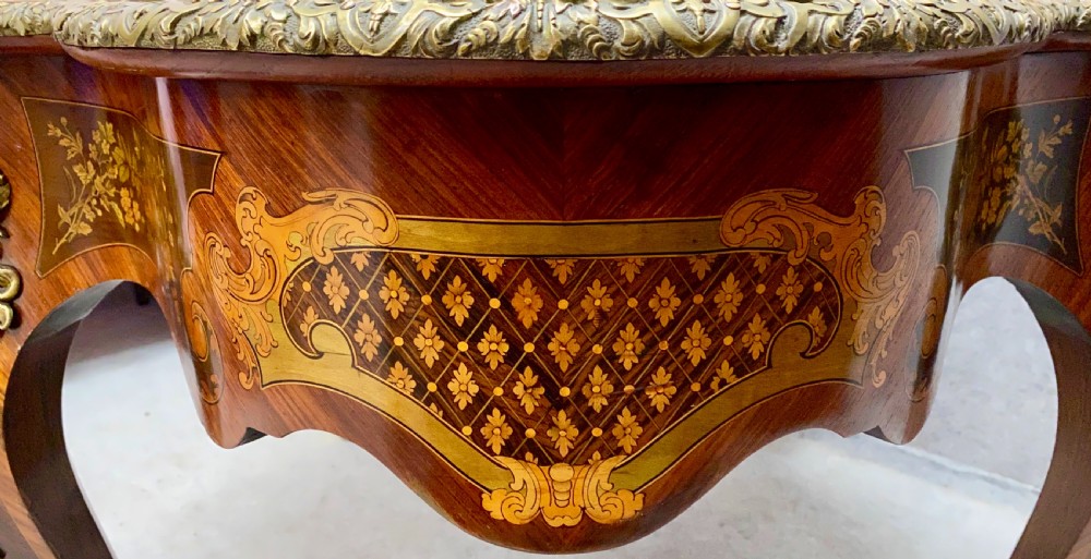 A French Louis XV style centre table featuring intricate floral marquetry inlay, a serpentine contoured top, cabriole legs, and bronze espagnolette mounts. View XI