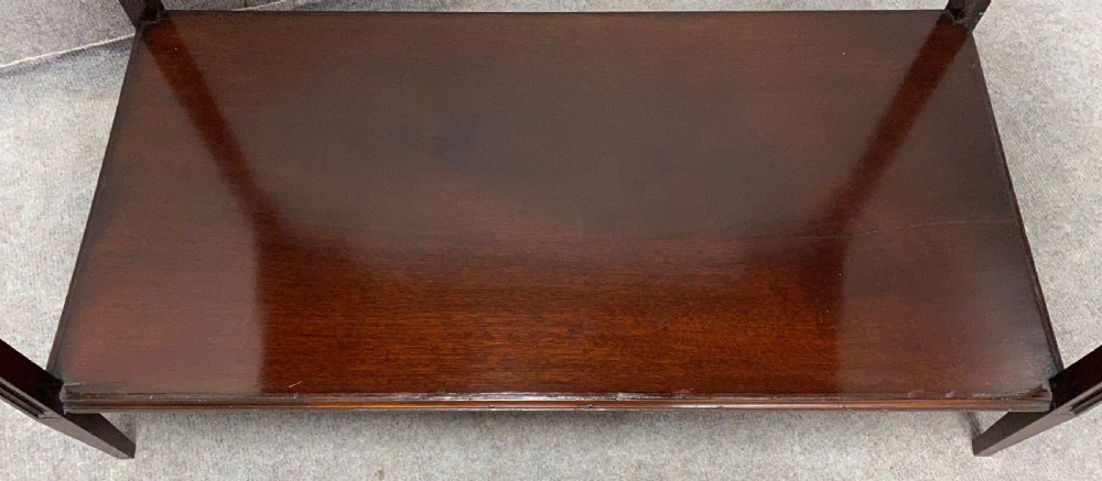 An antique glazed mahogany bijouterie table with a red fabric-lined display cavity, pierced fretwork corner brackets, and a lower shelf. View VII