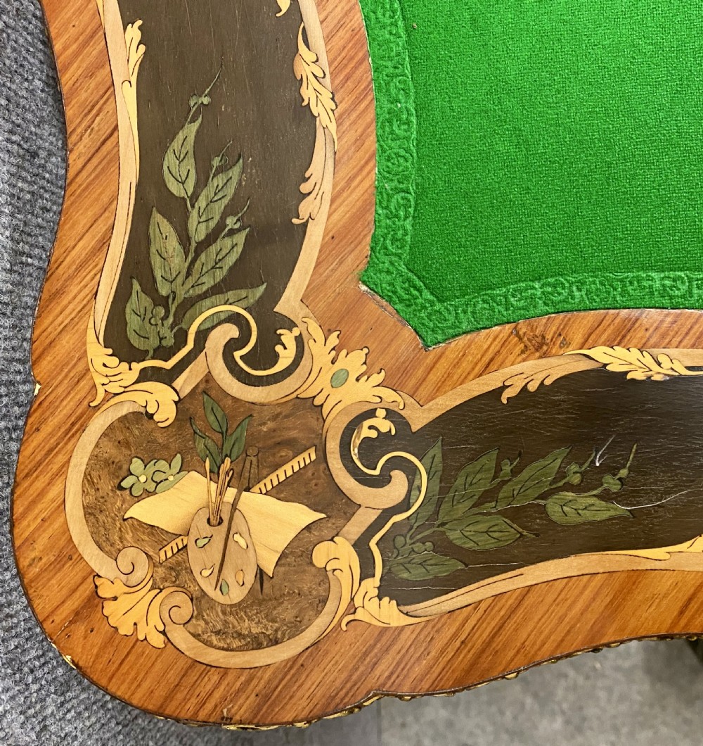 A Louis XV style serpentine card table featuring floral marquetry inlay, kingwood veneer, cabriole legs, and ornate gilt-bronze mounts. View XII