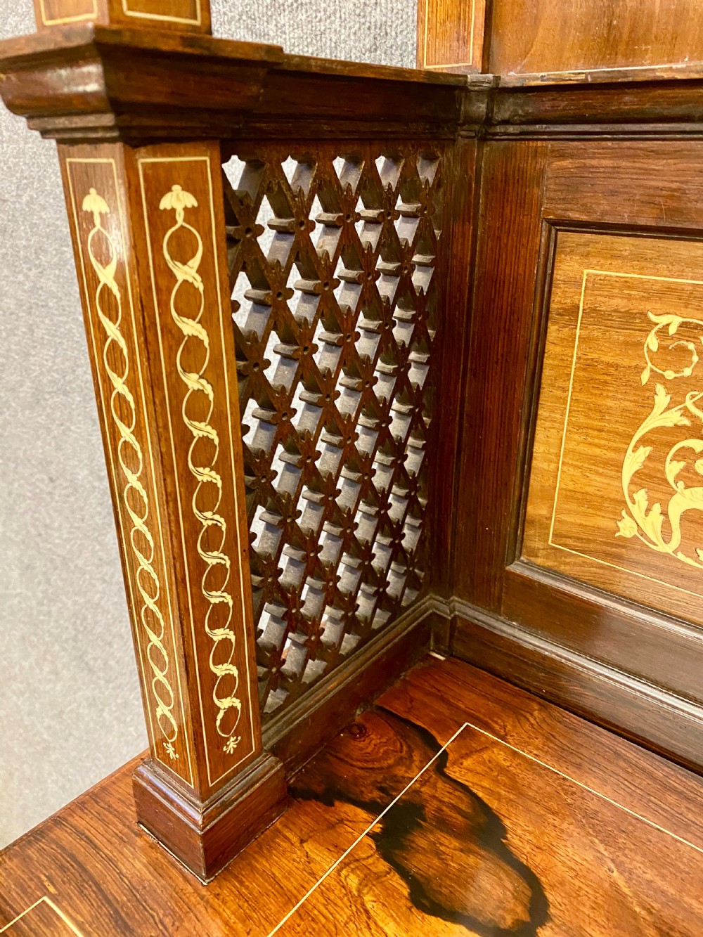 An Aesthetic Movement dark wood side cabinet featuring detailed marquetry inlays, an elevated superstructure with a central glazed cabinet, open niches, a mirror, a single drawer, and lower shelf spaces. View VII