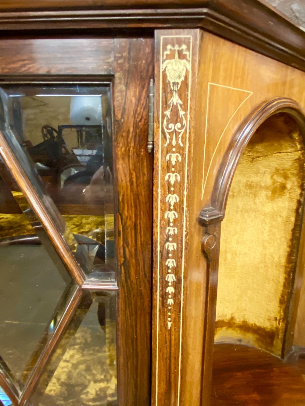 An Aesthetic Movement dark wood side cabinet featuring detailed marquetry inlays, an elevated superstructure with a central glazed cabinet, open niches, a mirror, a single drawer, and lower shelf spaces. View X