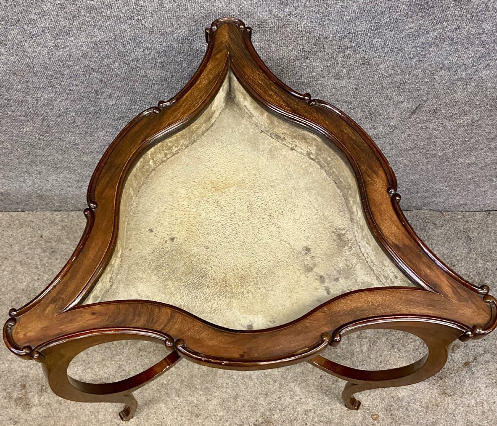A three-sided serpentine bijouterie table crafted from polished warm brown wood featuring a glass display lid and cabriole legs. View II