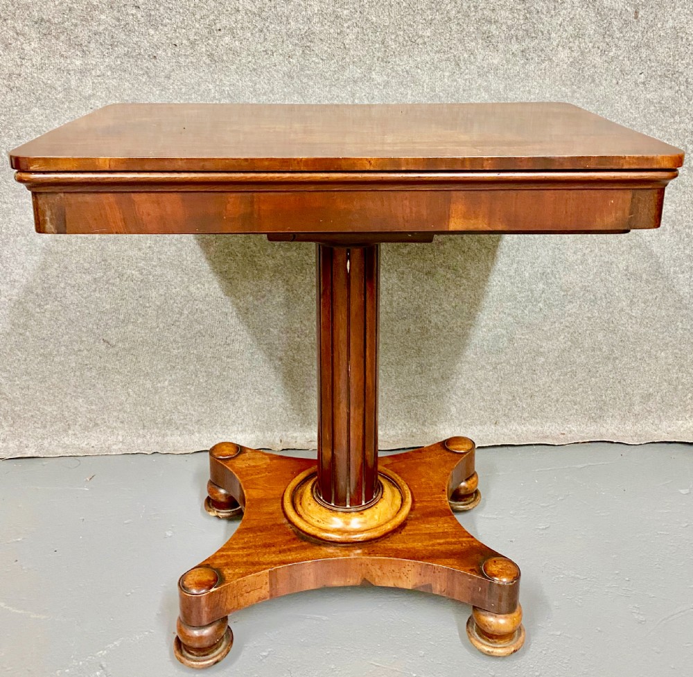 A three-tiered mahogany metamorphic dumb waiter table featuring fluted supports and a shaped quadform base. View II
