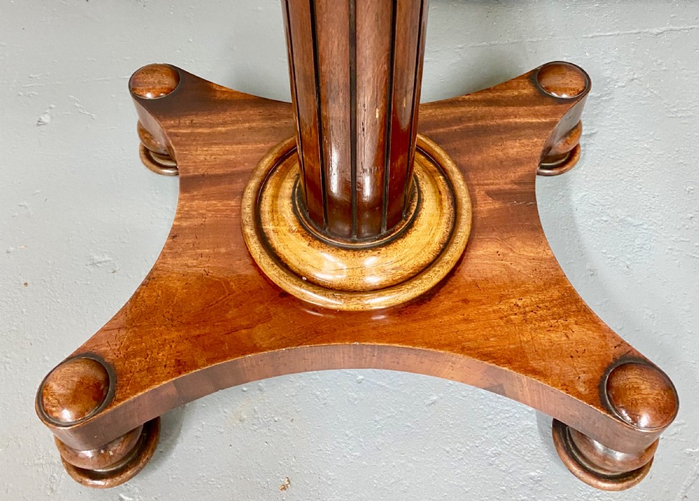 A three-tiered mahogany metamorphic dumb waiter table featuring fluted supports and a shaped quadform base. View X