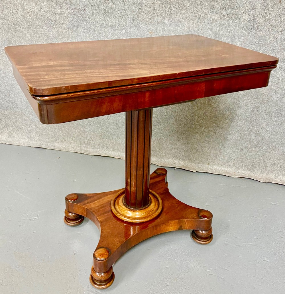 A three-tiered mahogany metamorphic dumb waiter table featuring fluted supports and a shaped quadform base. View XI