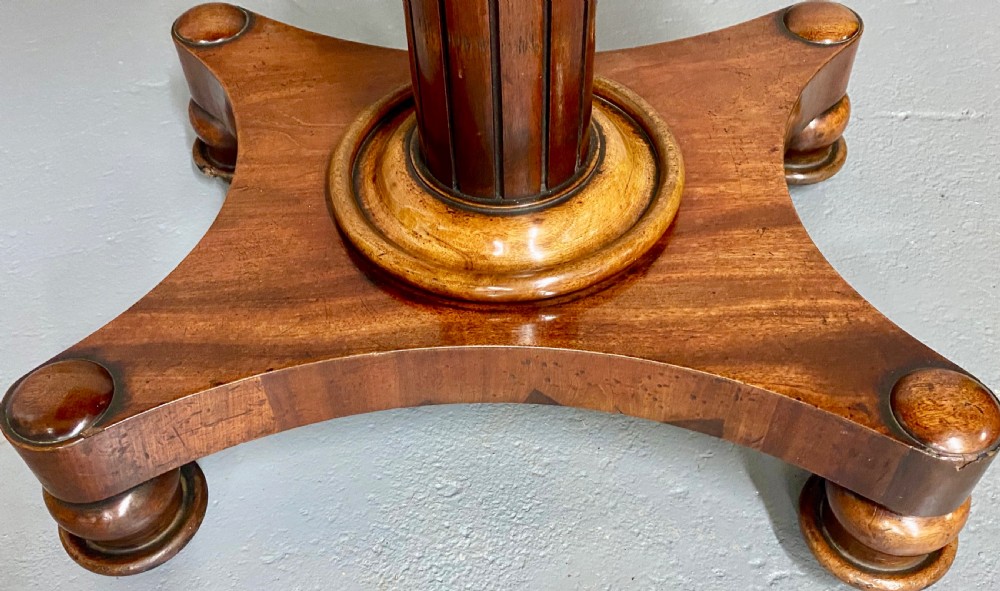 A three-tiered mahogany metamorphic dumb waiter table featuring fluted supports and a shaped quadform base. View XII