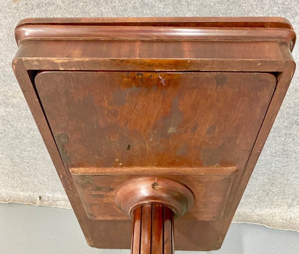 A three-tiered mahogany metamorphic dumb waiter table featuring fluted supports and a shaped quadform base. View XIII