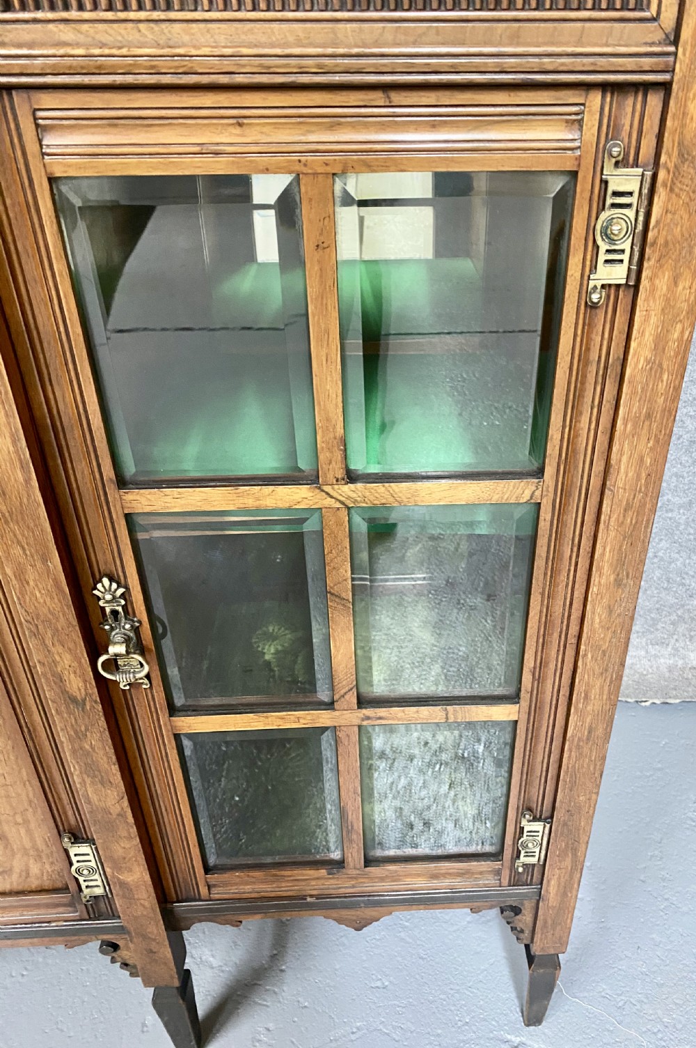 An antique inlaid rosewood side cabinet featuring glazed doors, mirrored inset panels, classical marquetry urn motifs, and a pediment top. View IV