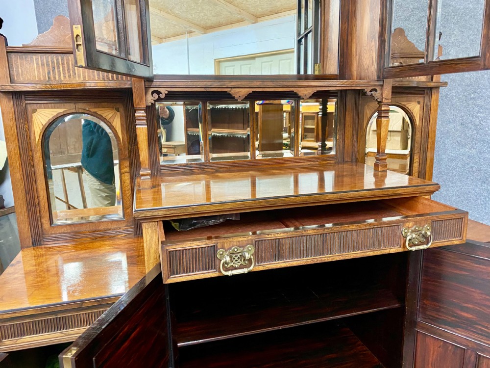 An antique inlaid rosewood side cabinet featuring glazed doors, mirrored inset panels, classical marquetry urn motifs, and a pediment top. View VIII