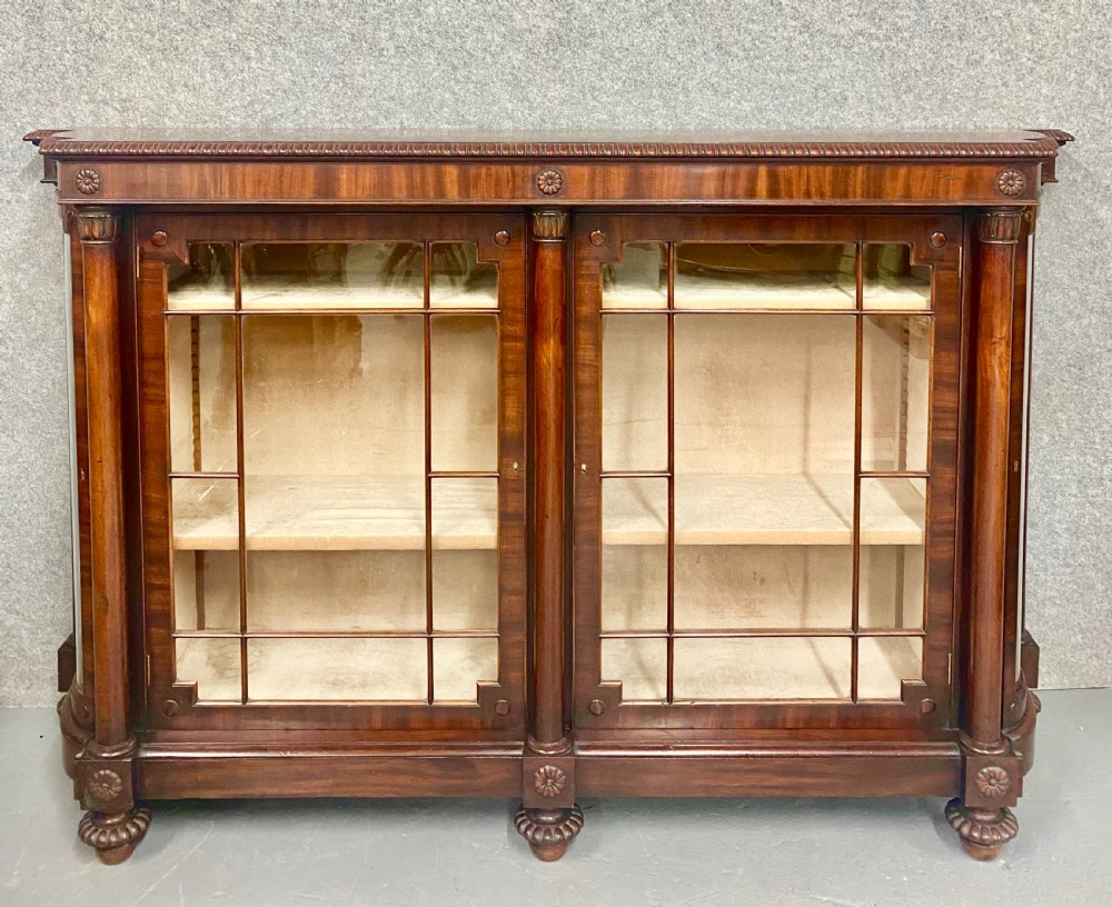 A nineteenth-century mahogany side cabinet featuring reeded columns, carved rosettes, gadrooned feet, and glazed doors. View III