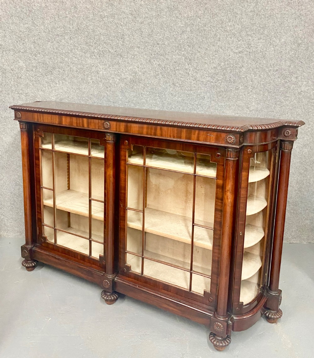 A nineteenth-century mahogany side cabinet featuring reeded columns, carved rosettes, gadrooned feet, and glazed doors. View IV