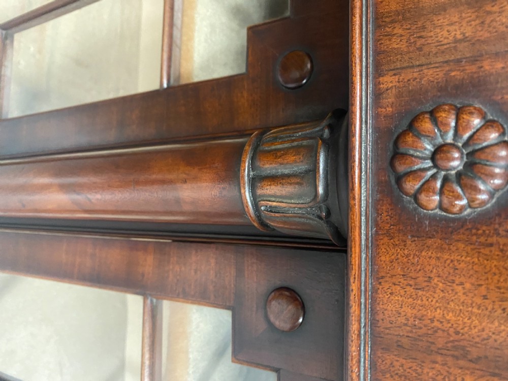 A nineteenth-century mahogany side cabinet featuring reeded columns, carved rosettes, gadrooned feet, and glazed doors. View V