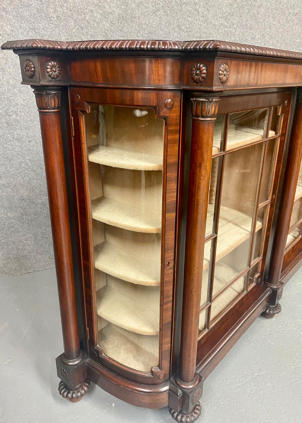 A nineteenth-century mahogany side cabinet featuring reeded columns, carved rosettes, gadrooned feet, and glazed doors. View VIII