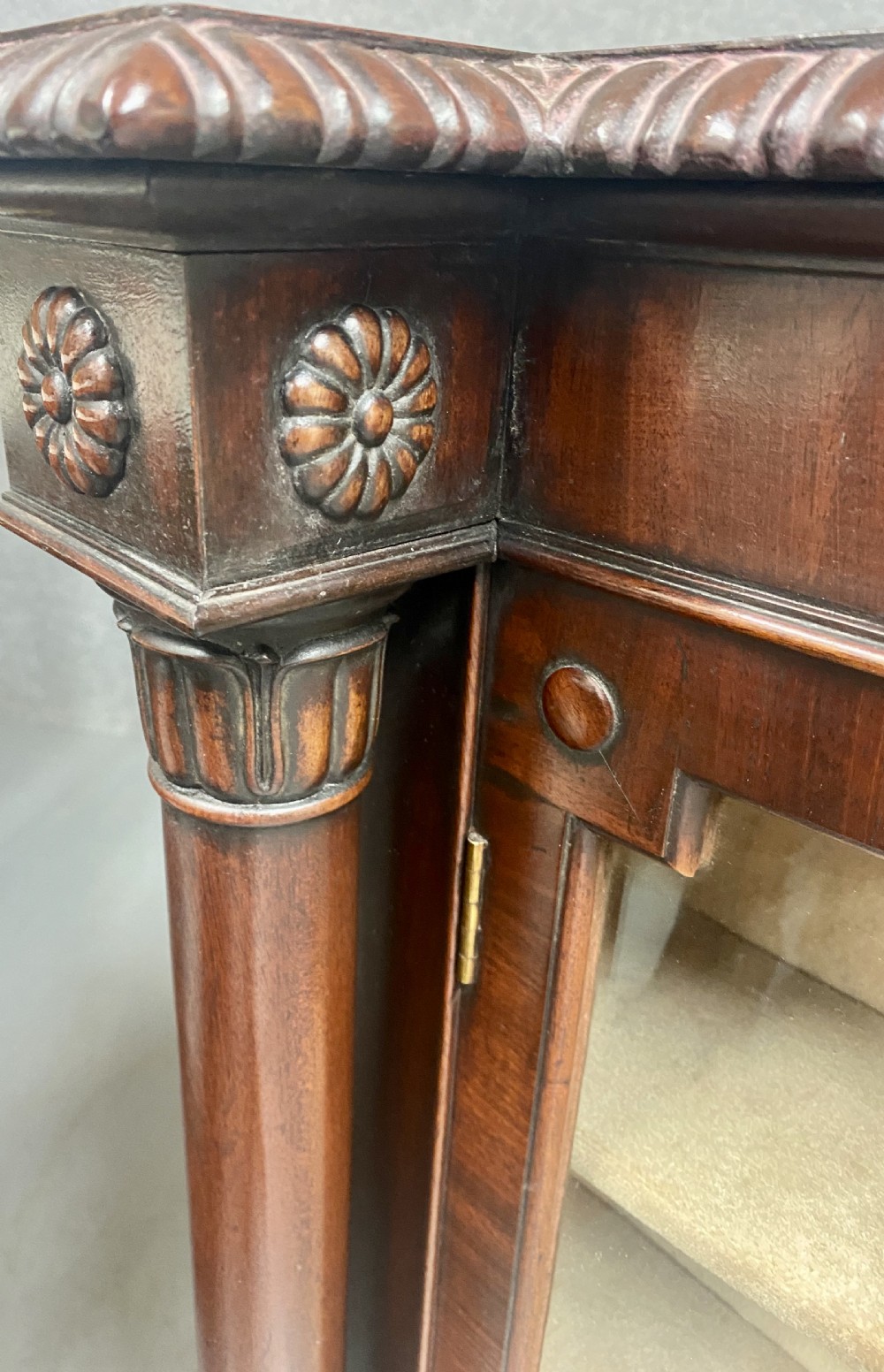 A nineteenth-century mahogany side cabinet featuring reeded columns, carved rosettes, gadrooned feet, and glazed doors. View IX