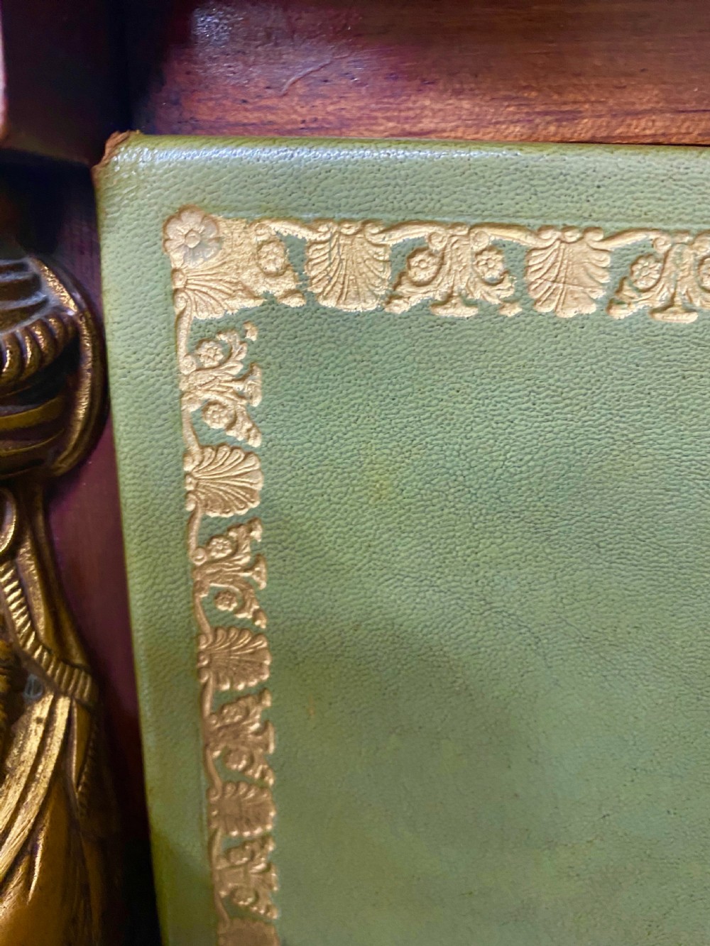 A pair of tall mahogany French Empire cartonnier chests featuring eight green gold-tooled leather drawers flanked by gilt ormolu mounts and terminal figures. View XII
