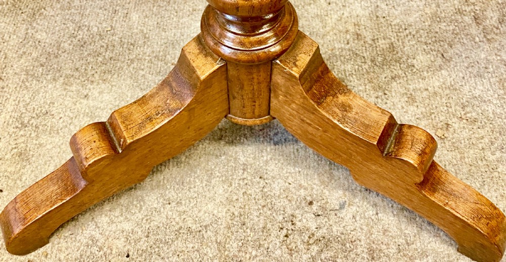 A pair of oak medieval style plant stands featuring hexagonal needlepoint tops decorated with fleur-de-lis and lion heraldic motifs on barley twist stems with tripod bases. View V