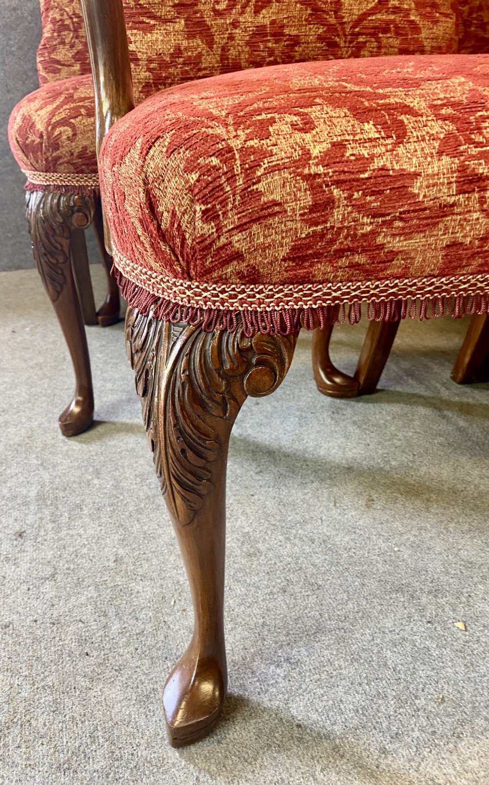 A nine-piece Queen Anne style dining room suite featuring a burr walnut dining table, matching sideboards, and red patterned fabric chairs with cabriole legs. View XIII