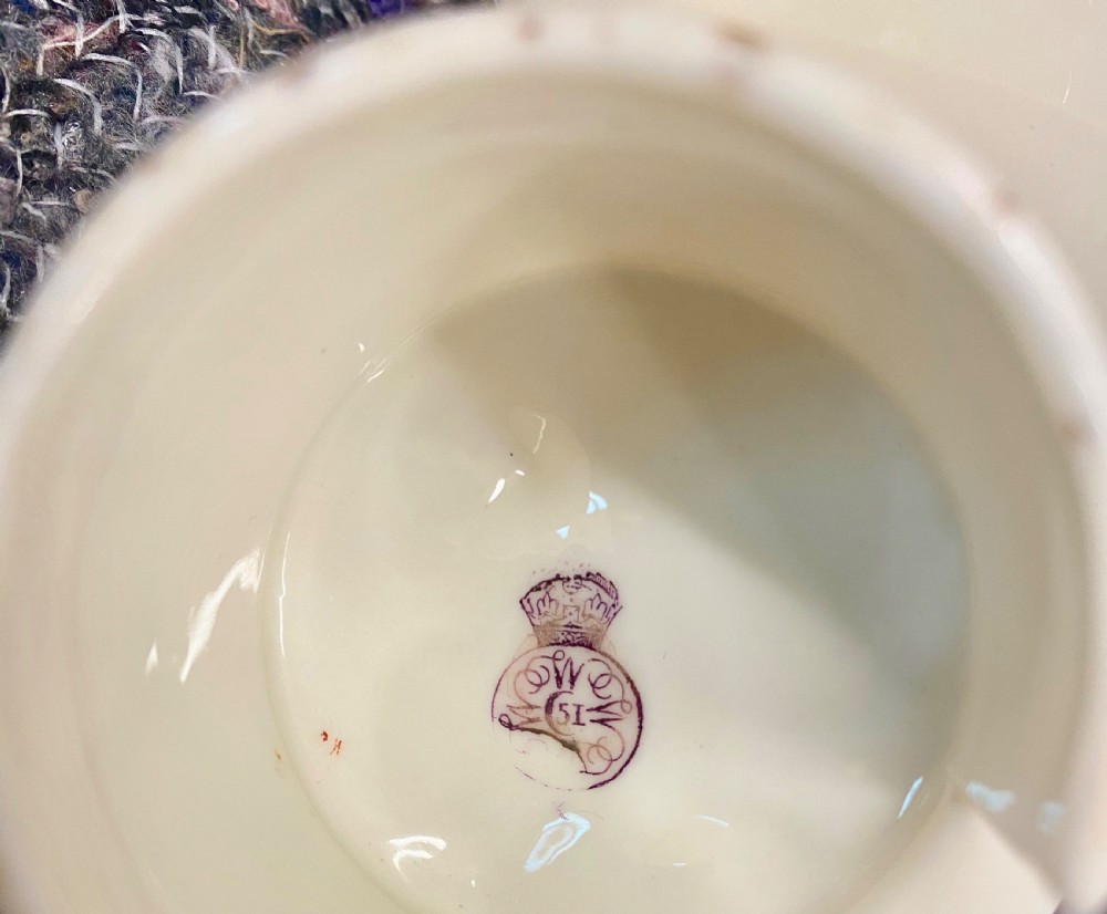 An antique ivory porcelain coffee pot featuring hand-painted floral motifs, relief blossom moulding, and a gilded lattice handle and finial. View V