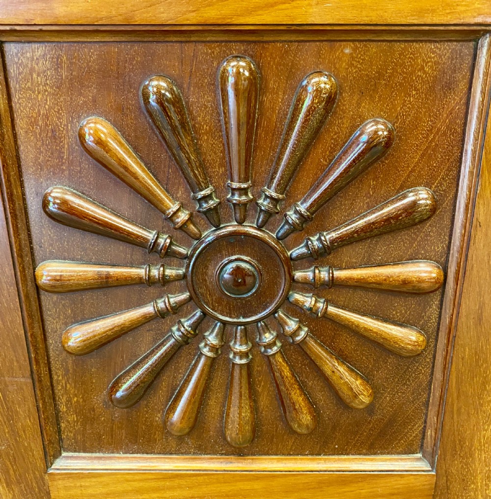 A late nineteenth-century Anglo-Moorish tiered wooden corner cabinet featuring mashrabiya fretwork, horseshoe arches, starburst door panels, and two drawers with brass pulls. View IX