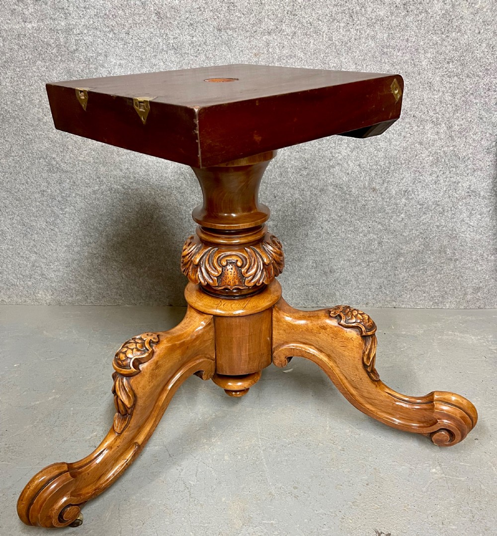 A circular Victorian burr walnut centre table featuring floral marquetry inlay on the top surface and supported by a carved pedestal base. View XI