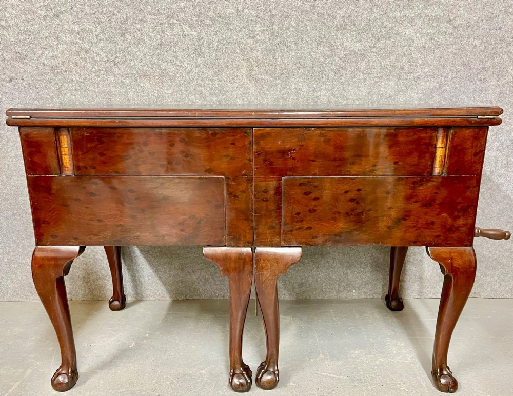 A George III mahogany metamorphic library table featuring a green leather writing surface, a fitted interior of small drawers, and cabriole legs ending in claw and ball feet. View II
