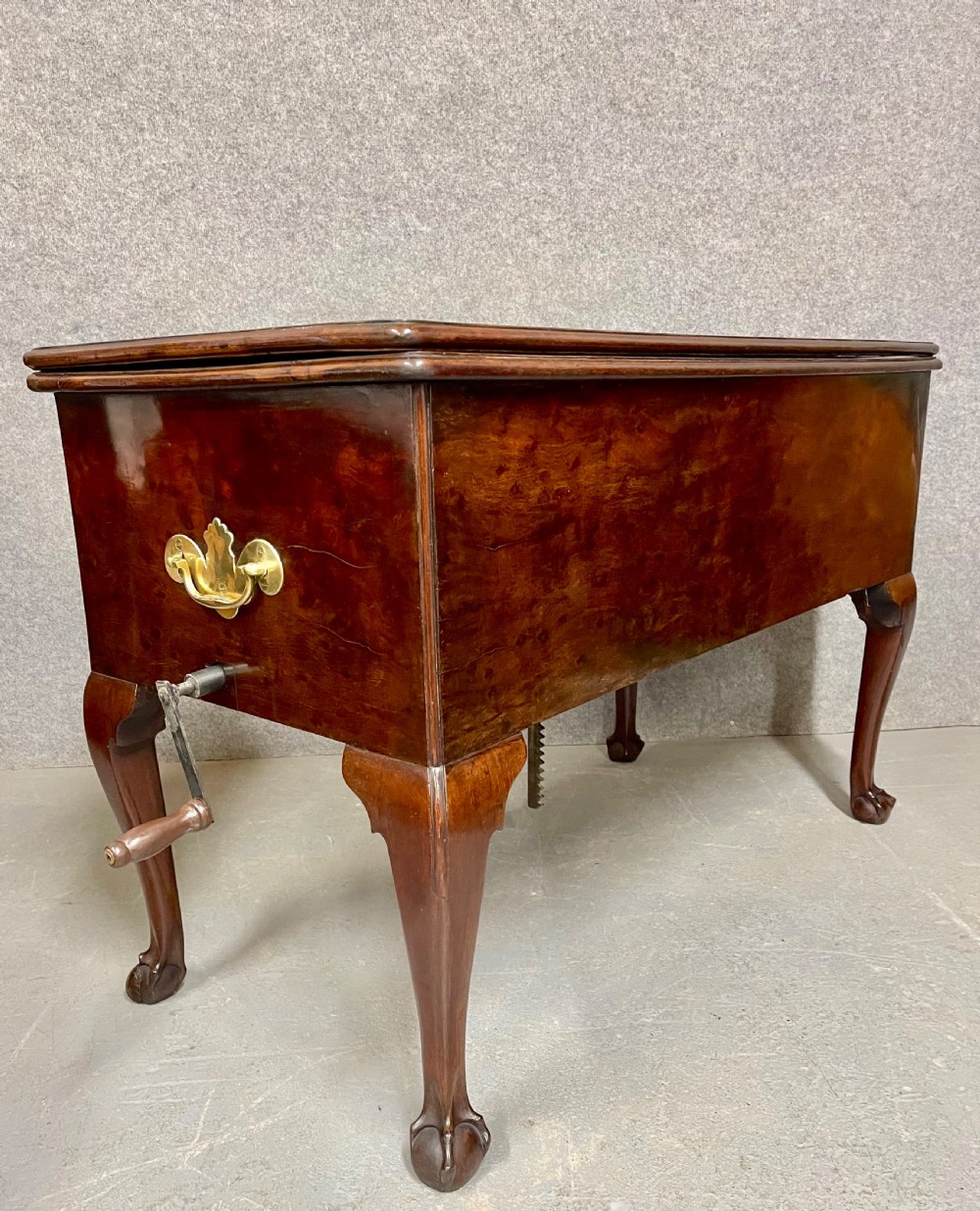 A George III mahogany metamorphic library table featuring a green leather writing surface, a fitted interior of small drawers, and cabriole legs ending in claw and ball feet. View III