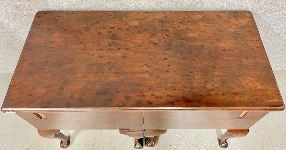 A George III mahogany metamorphic library table featuring a green leather writing surface, a fitted interior of small drawers, and cabriole legs ending in claw and ball feet. View VII