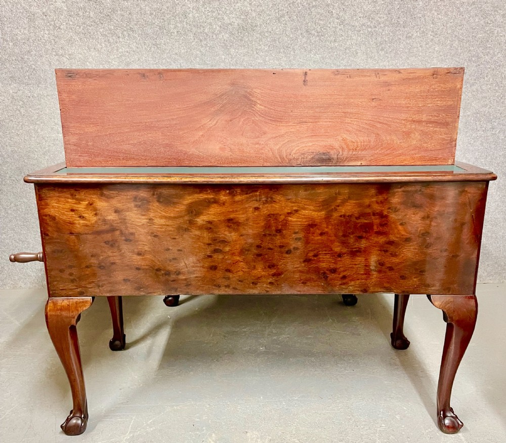 A George III mahogany metamorphic library table featuring a green leather writing surface, a fitted interior of small drawers, and cabriole legs ending in claw and ball feet. View XI