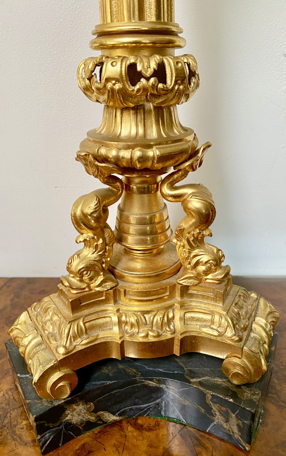 An antique ormolu oil lamp featuring a fluted Corinthian column base, a cut crystal reservoir, and an etched glass shade with a ruffled green rim. View II