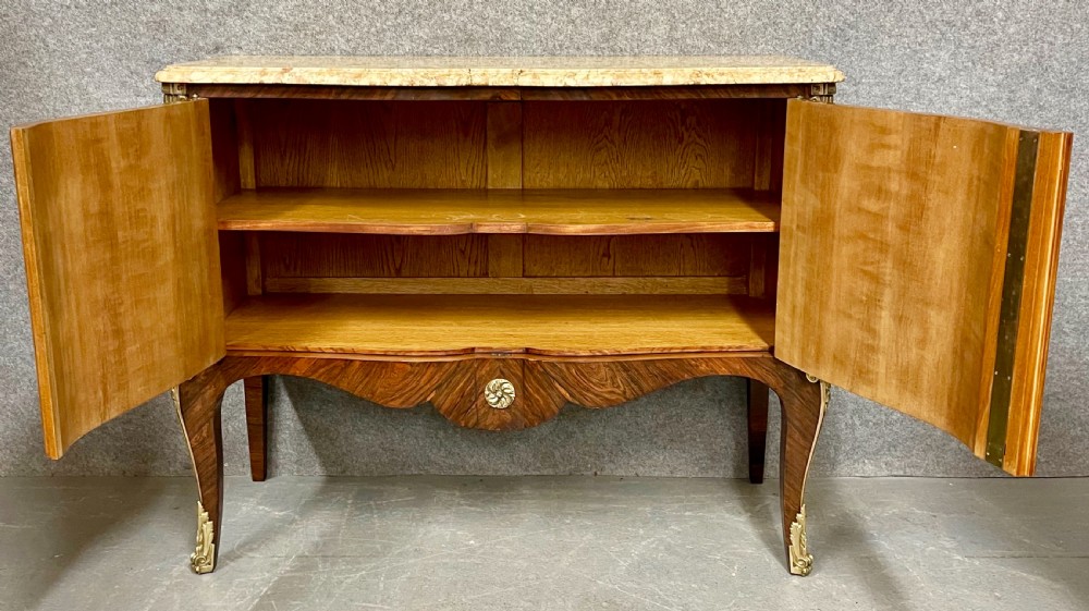 A French Chinoiserie marquetry commode featuring curved doors with inlaid pictorial scenes, a marble top, and gilt bronze mounts on cabriole legs. View VII