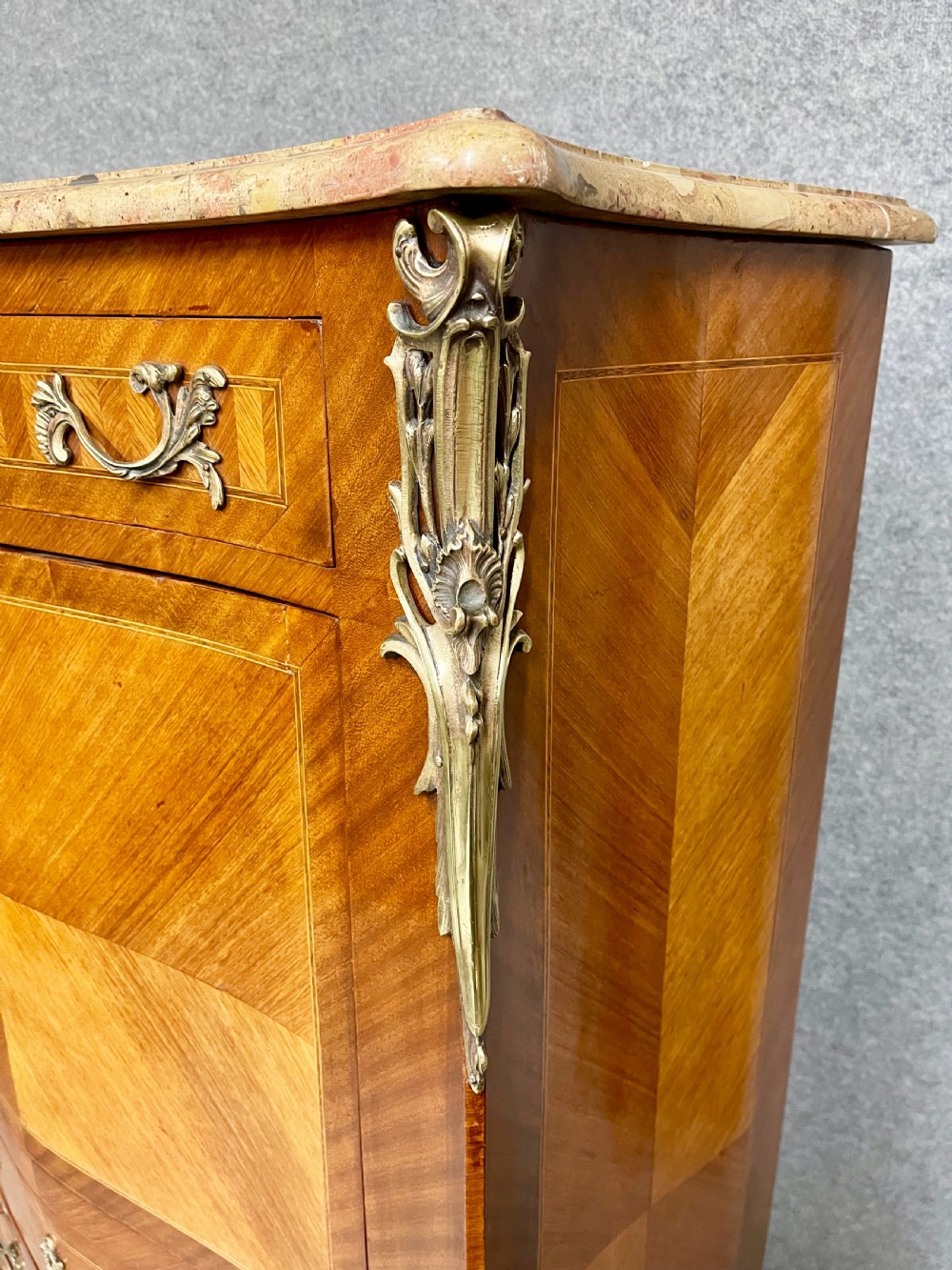 A French kingwood escritoire writing desk featuring a fall-front green leather-lined surface, fitted interior drawers, gilt-bronze mounts, and a marble top. View VI