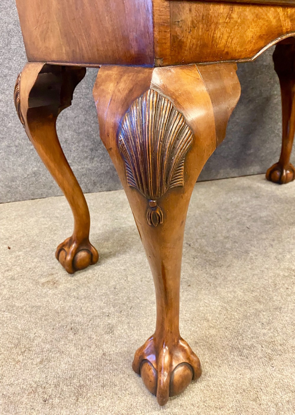 A George I style walnut chest of drawers mounted on a carved stand with cabriole legs and ball-and-claw feet. View III