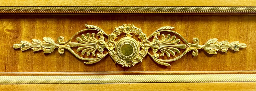 A pair of French Neoclassical side cabinets featuring satinwood parquetry, intricate gilt-bronze mounts, corner bust sculptures, and pink marble tops. View XI
