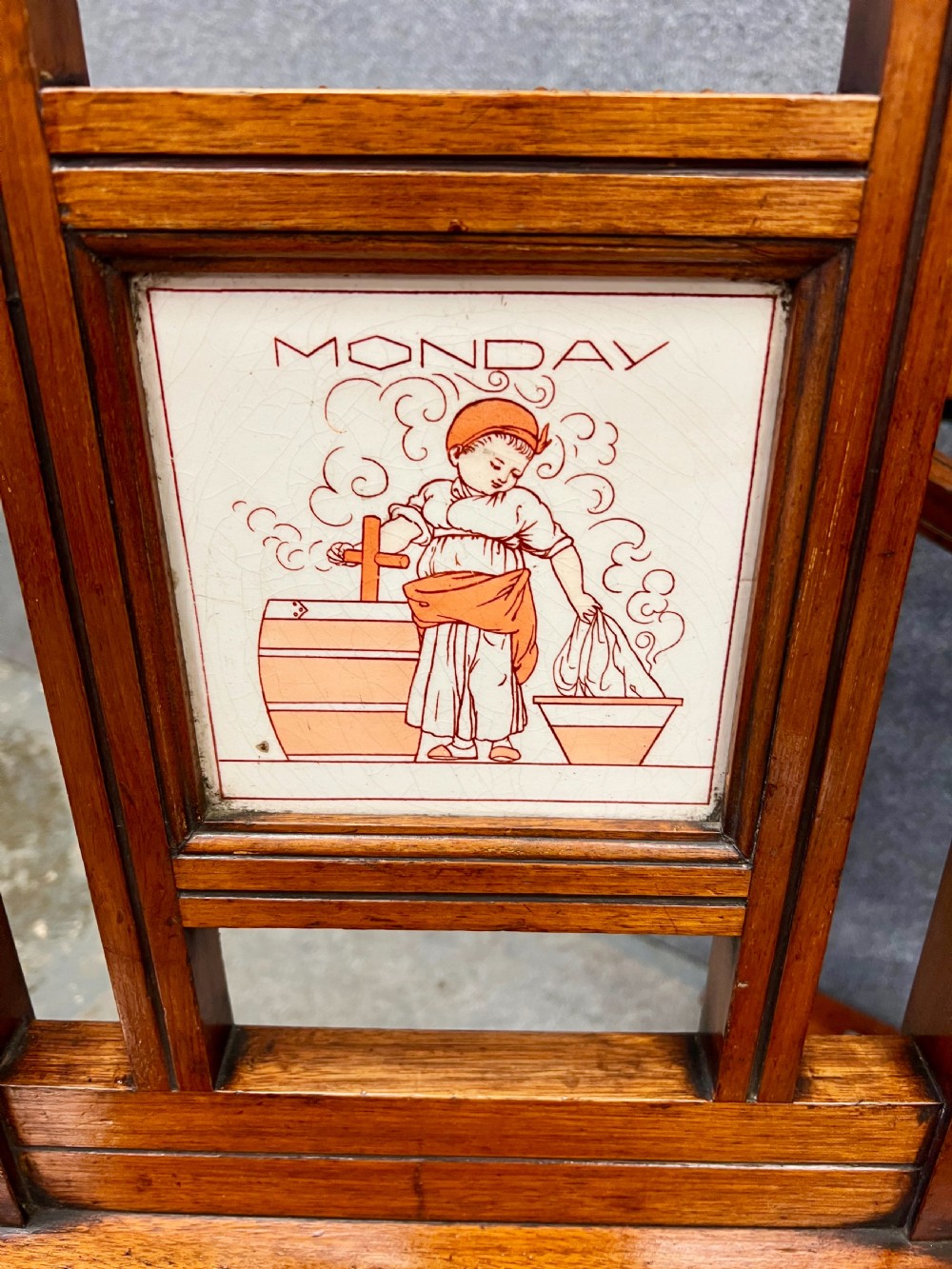 A late 19th-century mahogany hall stand featuring a central mirror, brass hooks, inlaid Minton ceramic tiles, and two matching side chairs. View II