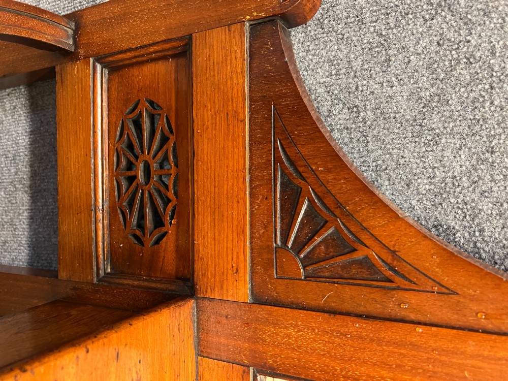 A late 19th-century mahogany hall stand featuring a central mirror, brass hooks, inlaid Minton ceramic tiles, and two matching side chairs. View XIV