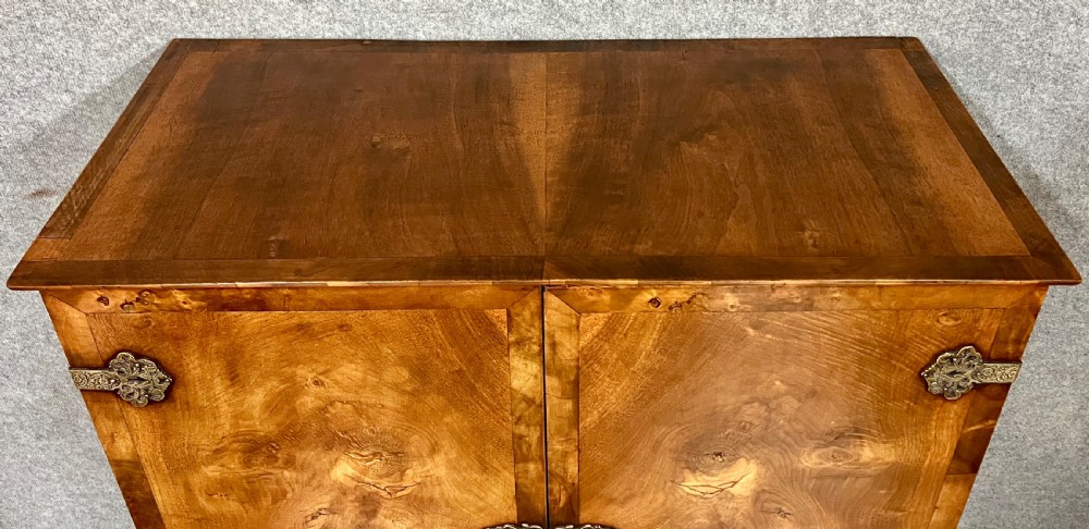 A William and Mary style burr walnut cocktail cabinet on stand featuring engraved brass strap hinges, double doors, a single drawer, turned legs, and a shaped stretcher. View XIII