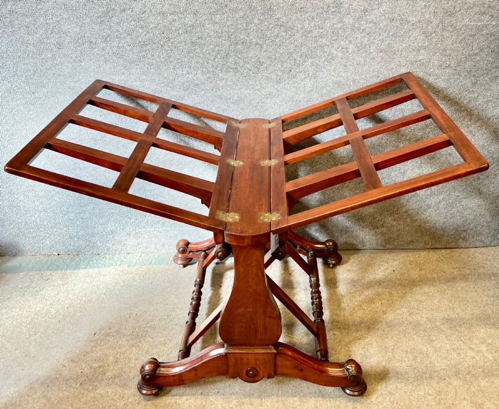 A George IV mahogany folio stand with hinged slatted frames, turned stretchers, and carved scrolled feet. View VII