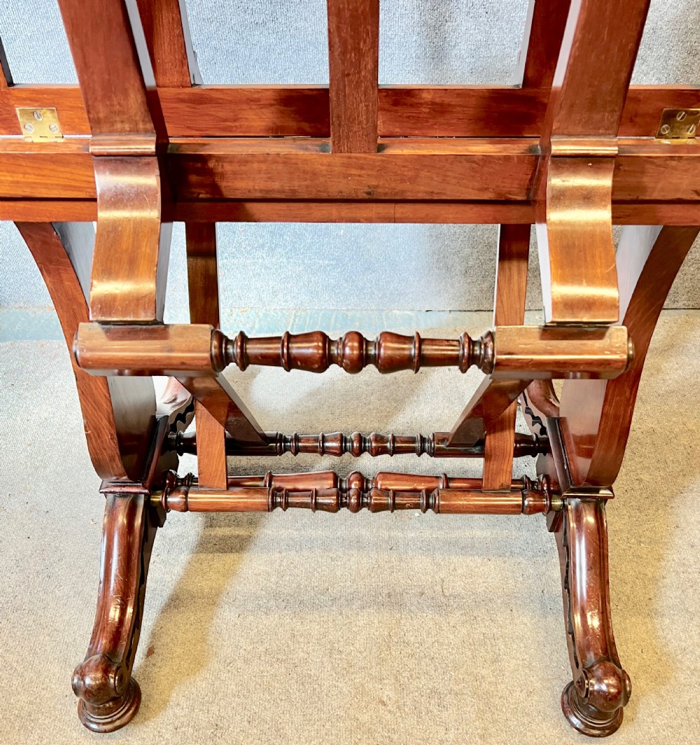 A George IV mahogany folio stand with hinged slatted frames, turned stretchers, and carved scrolled feet. View IX
