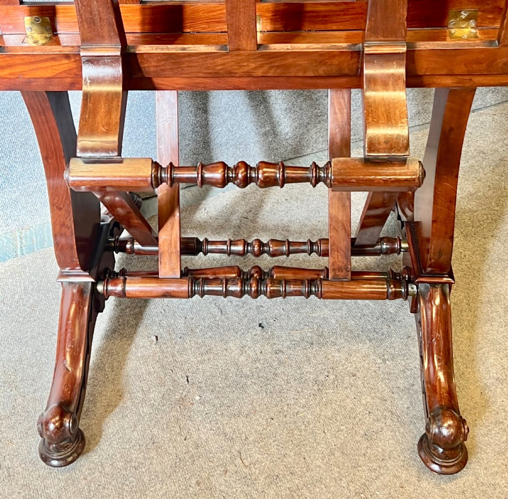 A George IV mahogany folio stand with hinged slatted frames, turned stretchers, and carved scrolled feet. View XIII