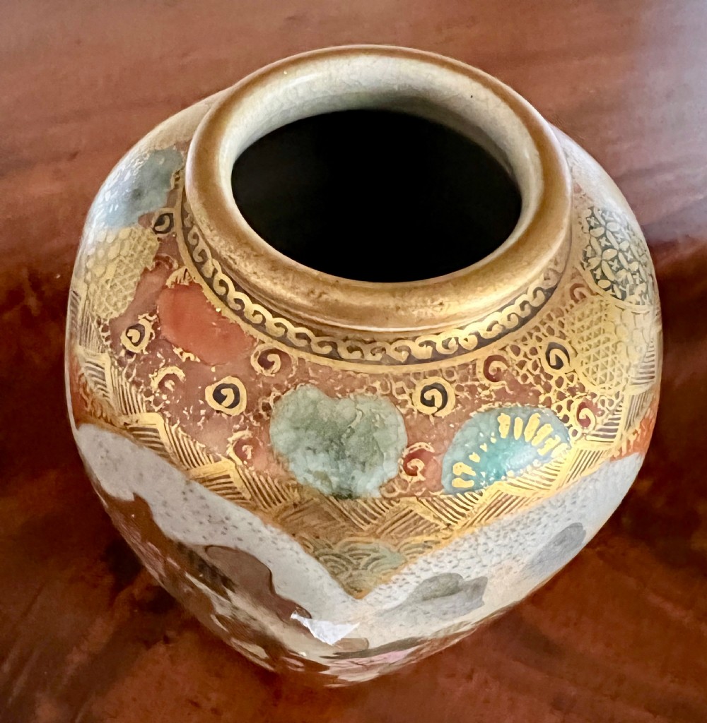 A small Japanese Satsuma earthenware vase featuring hand-painted figures, landscape scenes, geometric gold patterns, and a crackled cream glaze. View IV