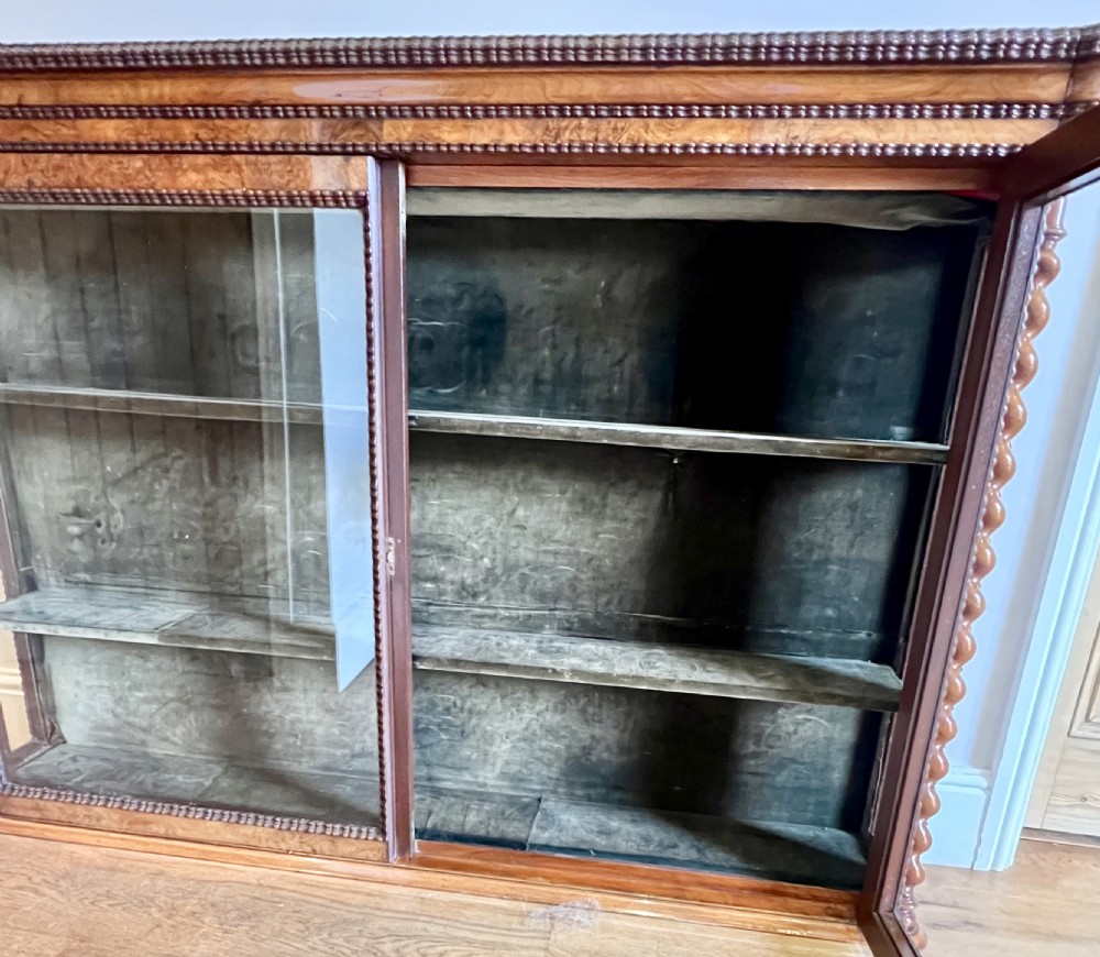 A Victorian wall-hanging mahogany display cabinet featuring two glazed doors, glass side panels, interior shelves, and carved barley twist side columns. View V