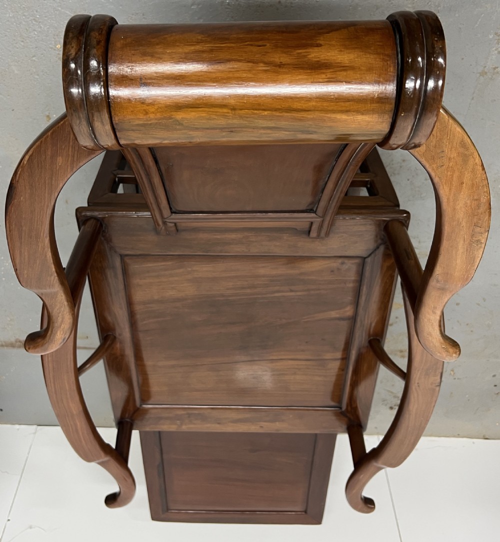 A Chinese polished dark hardwood stargazer chair featuring curved armrests, a raised cylindrical headrest, and an extendable carved footrest. View IV