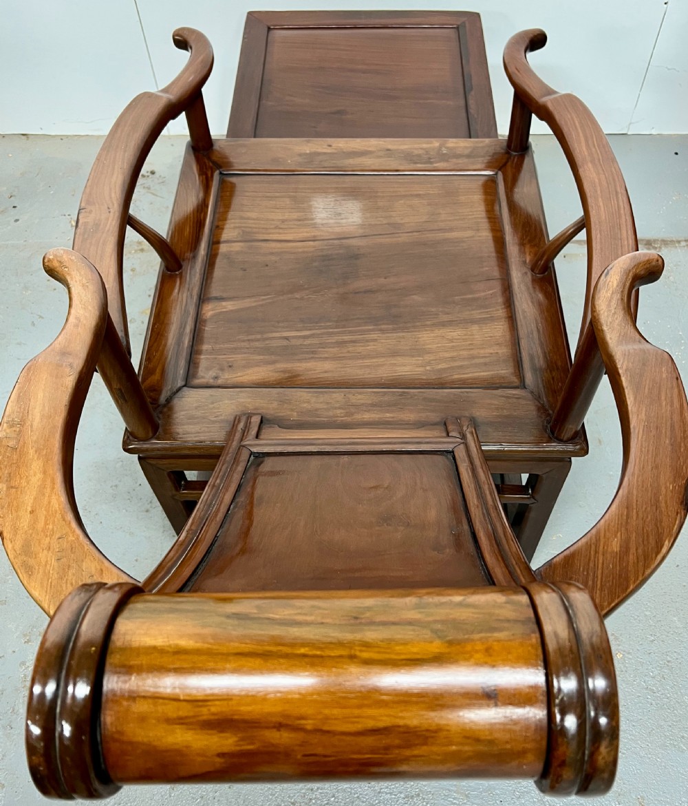 A Chinese polished dark hardwood stargazer chair featuring curved armrests, a raised cylindrical headrest, and an extendable carved footrest. View V