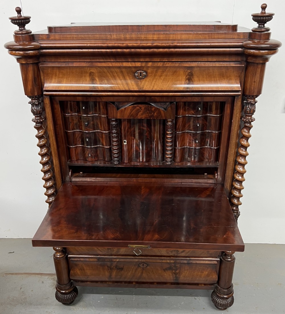 A 19th-century Biedermeier flame mahogany secretaire desk featuring spiralled barley twist columns, a fall-front writing surface, and a fitted interior cabinet. View III