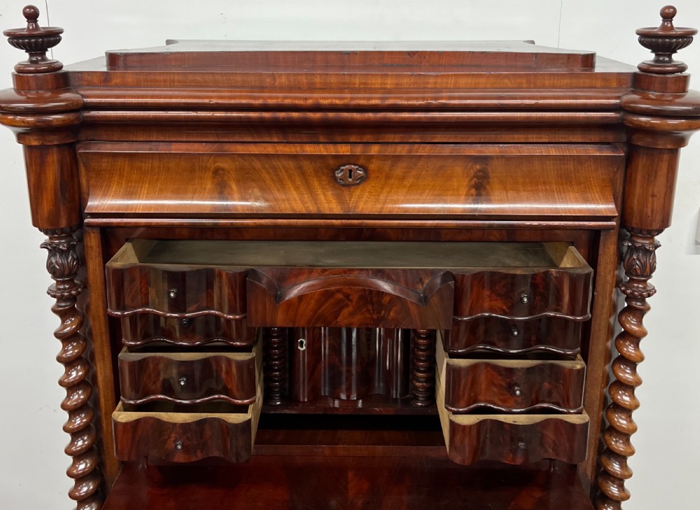 A 19th-century Biedermeier flame mahogany secretaire desk featuring spiralled barley twist columns, a fall-front writing surface, and a fitted interior cabinet. View IV
