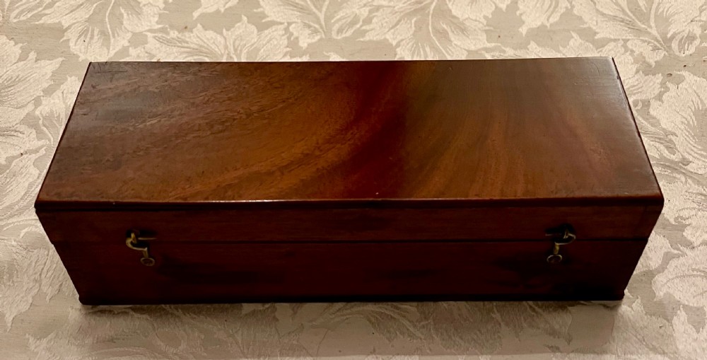 An open mahogany case containing a brass chondrometer grain scale with its balance beam, measuring bucket, and original instructional label on the inner lid. View IV