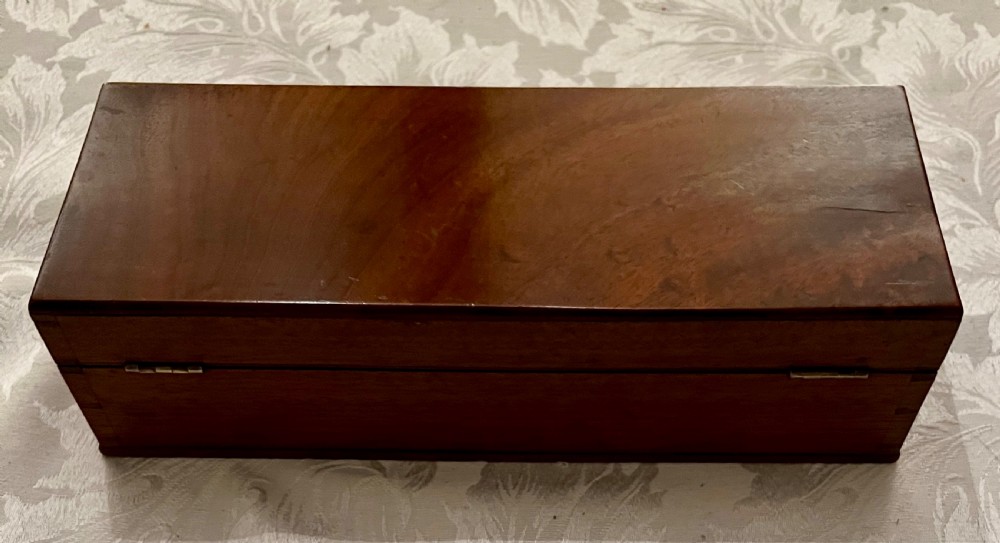 An open mahogany case containing a brass chondrometer grain scale with its balance beam, measuring bucket, and original instructional label on the inner lid. View V