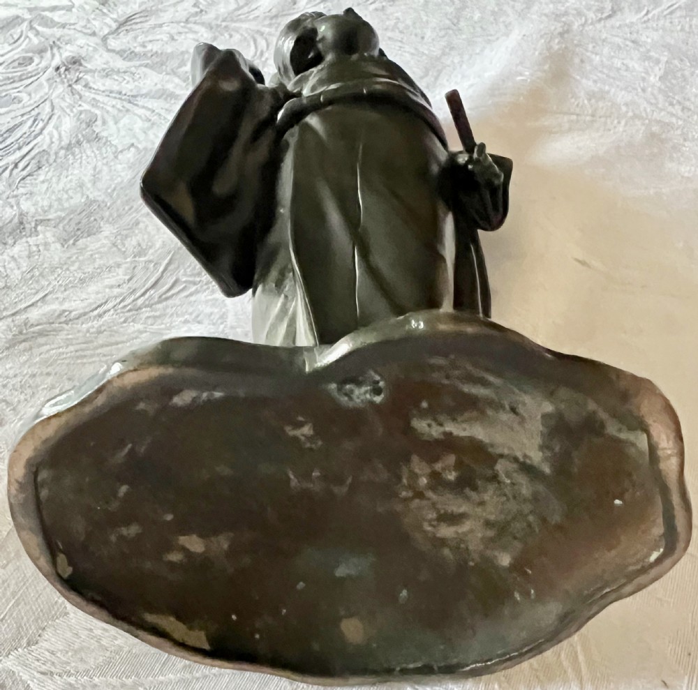 A dark patinated bronze figure depicting a Japanese woman in a traditional kimono with an intricate hair arrangement on an integral base. View VII