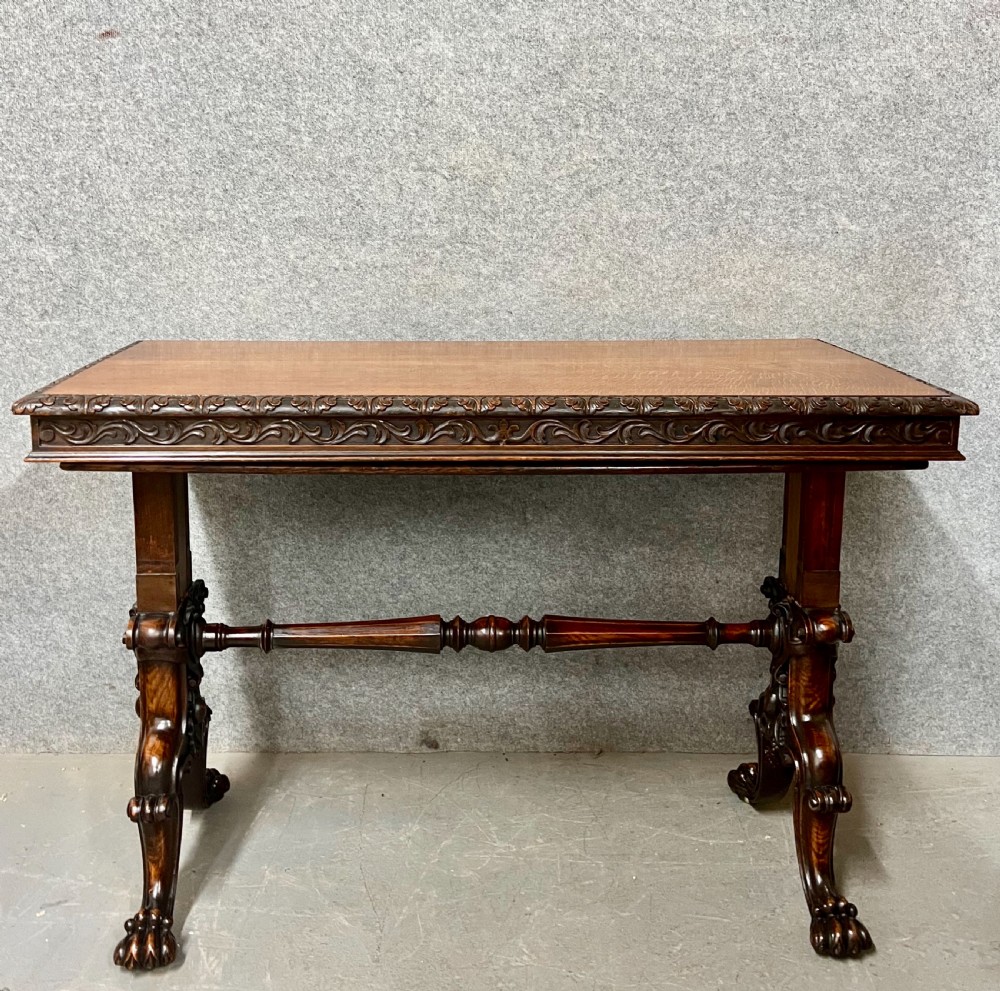 A dark oak Victorian rise and fall three-tiered dumb waiter with carved foliage borders and ornate leg supports. View VIII